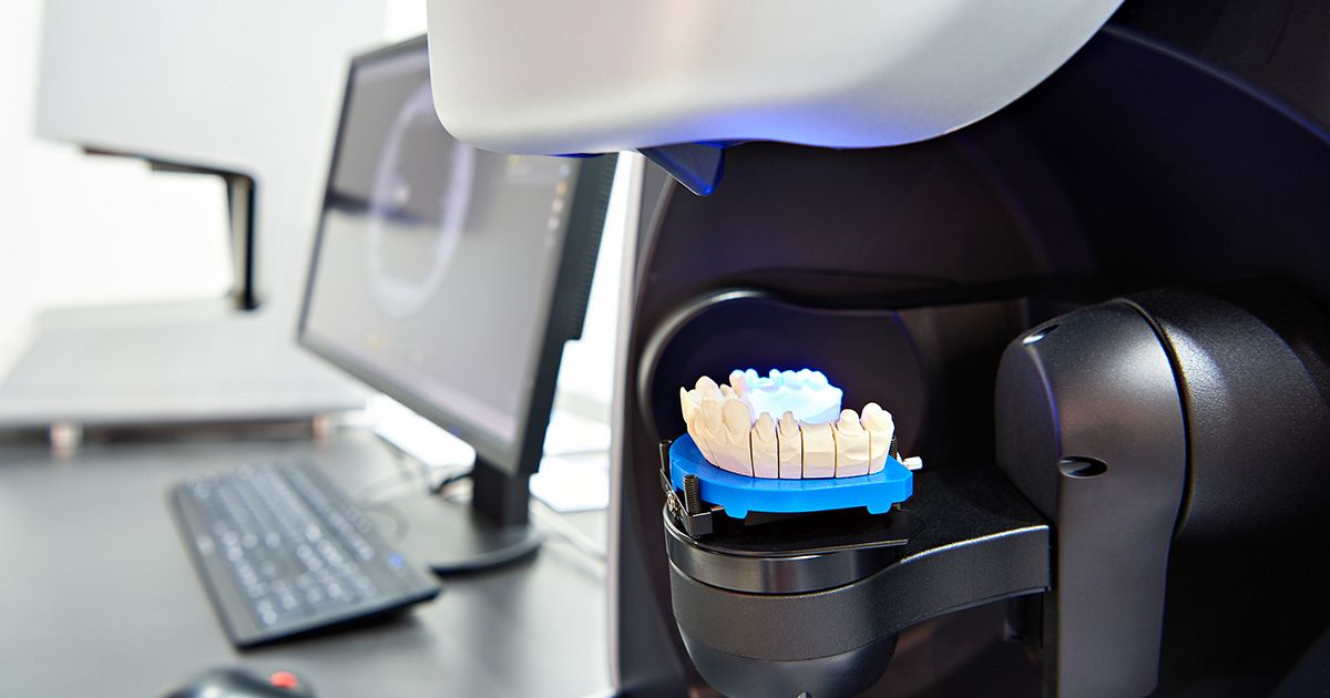 dental lab management software on computer and hardware with teeth